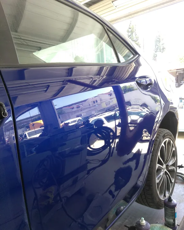 Close-up of a glossy blue custom paint finish, SV Collisions