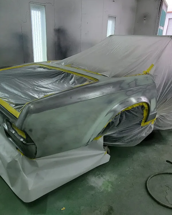 Vehicle wrapped and prepped for paint on the lift at SV Collisions