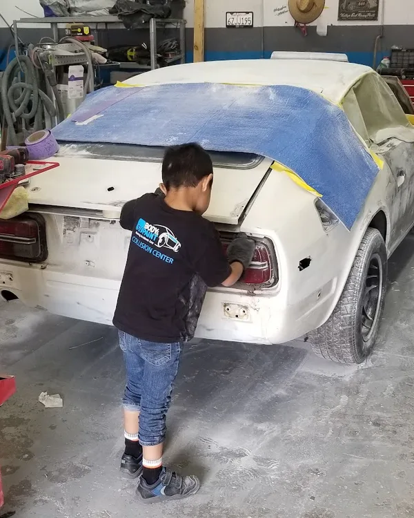 SV Collisions technician masking a car for paint prep, El Cajon shop