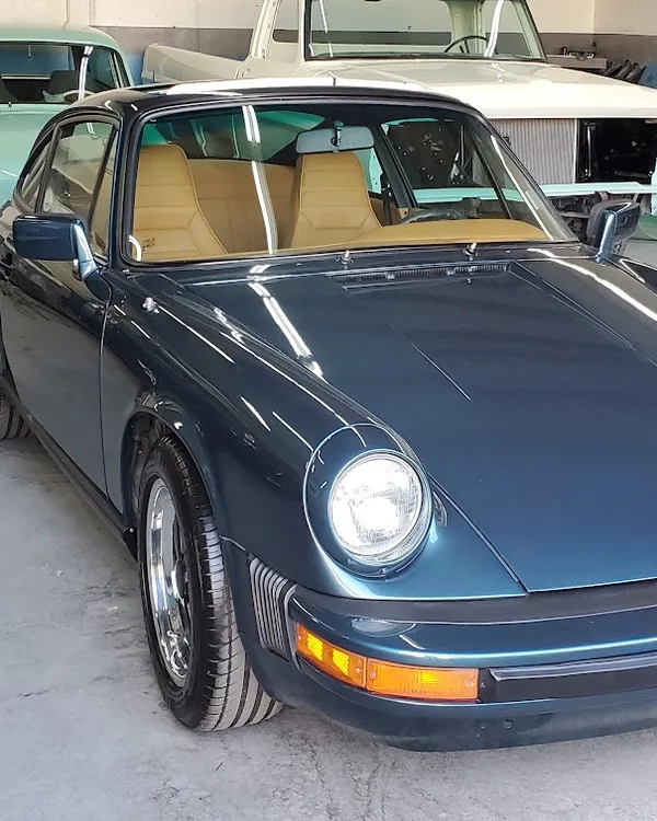 Classic Porsche 911 among other vintage cars in the SV Collisions shop, El Cajon